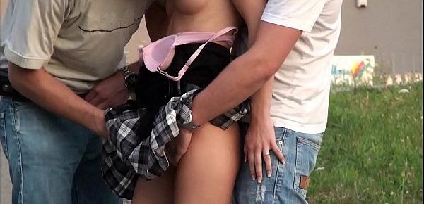  A young tiny girl is fucked buy a huge dick in a public threesome